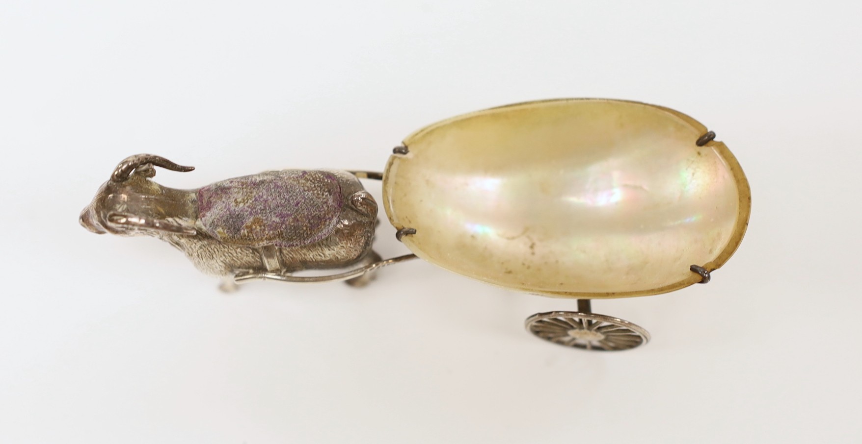 A George V silver and mother of pearl mounted novelty pin cushion, modelled as a goat pulling a cart, Adie & Lovekin, Birmingham, 1911, 11.2cm.